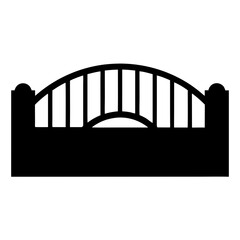 Silhouette of an arched wrought iron gate with pillars and pickets