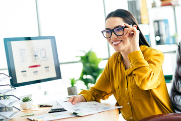 Skilled professional businesswoman in a modern office dressed stylishly and working...
