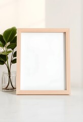 Minimalist interior, wooden frame, blank canvas, white wall, houseplant, ceramic vase, sunlight, shadows, clean aesthetic, Scandinavian design