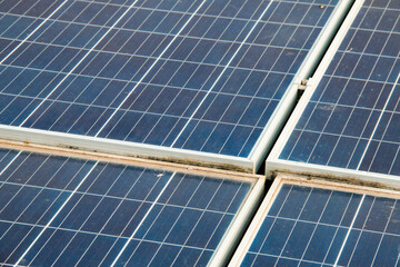 Solar panels with visible dirt and dust mounted on a rooftop. Represents the importance of maintenance for sustainable and efficient renewable energy usage.