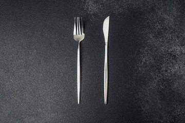 Cutlery set featuring a fork and knife on a dark background