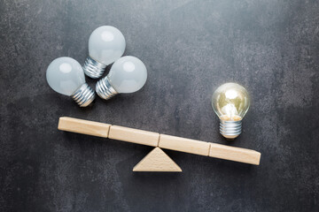 A single light bulb lit weighs more than several light bulbs extinguished on a weighing scale