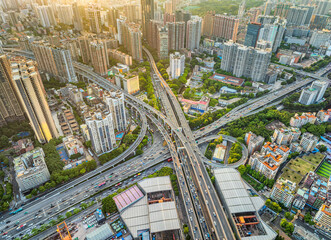 Aerial view of a complex highway interchange and dense urban buildings in the city of Guangzhou....