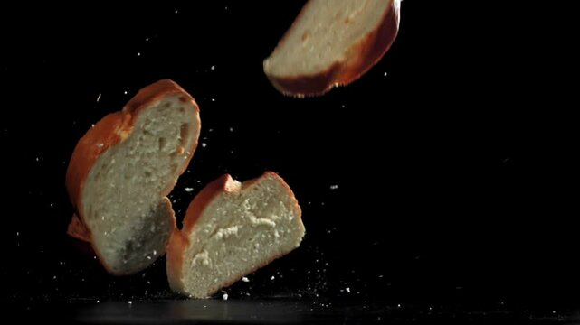 Pieces of bread falling on a black background. Filmed on a high-speed camera at 1000 fps. High quality FullHD footage