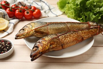 Delicious smoked herrings on white wooden table, closeup