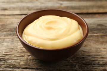 Tasty vanilla pudding on wooden table, closeup
