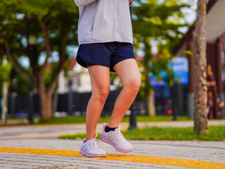 Fit leg woman asian jogging workout on street in the park, focus to healthy and wellness. Close up...
