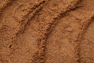 Superfood supplement. Nutmeg powder as background, closeup