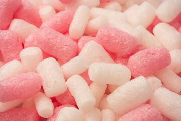 Pink and white box filler as a background. Top view.