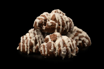 Profiteroles with coconut cream on a black background.