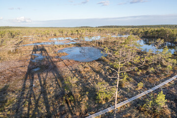 Estonia - April 26 2025: Aerial View of Konnu Suursoo Raised Bog from observation tower. Spring Morning. Wooden Duckboards Over Floating Peat Moss, Deep Hollows, and the Wetland Landscape.