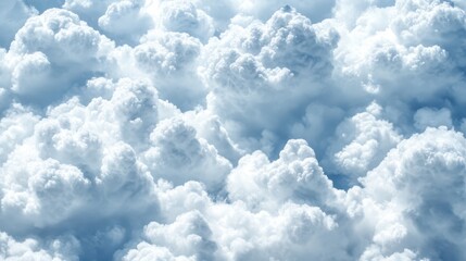 Close-up view of fluffy white cumulus clouds.