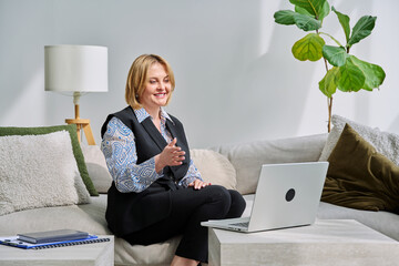 Business middle aged woman having video conference chat using laptop