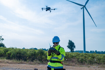 Obraz premium Engineers using drone to inspect wind farm
