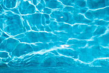Blue Water Pool Surface with Sunlight Reflections