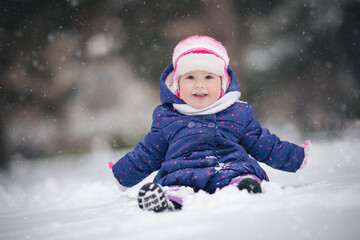 Baby girl playing with snow for the first time