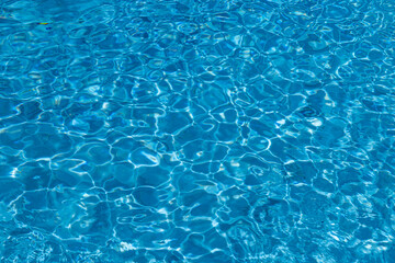 Blue Water Pool Surface with Sunlight Reflections