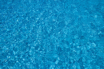 Blue Water Pool Surface with Sunlight Reflections