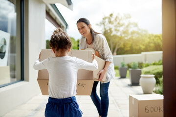 Mother, child and helping with boxes in new home for property investment, relocation and fresh...