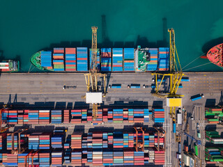 Aerial view of busy container terminal and cargo cranes