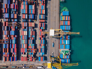 Aerial view of busy container terminal and cargo cranes