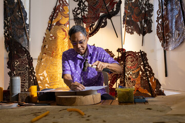 Craftsmen create traditional Thai Khon puppets.