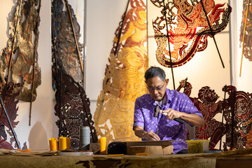 Craftsmen create traditional Thai Khon puppets.