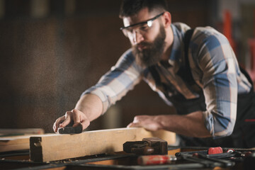 Young carpenter working in his workshop