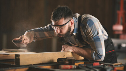 Young carpenter working in his workshop