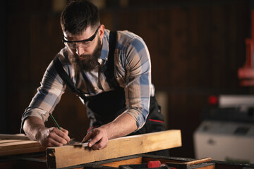 Young carpenter working in his workshop