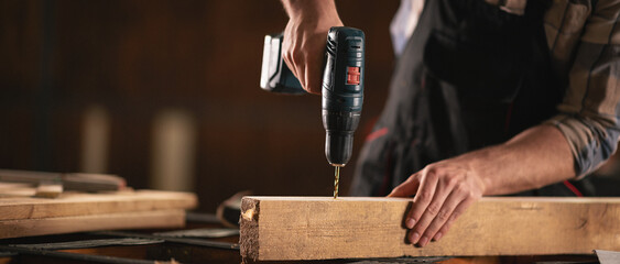 Young carpenter working in his workshop
