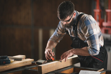 Young carpenter working in his workshop