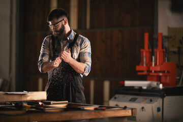 Young carpenter working in his workshop