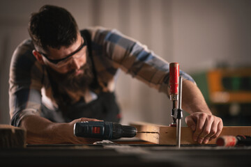Young carpenter working in his workshop