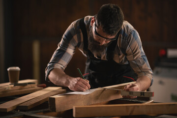 Young carpenter working in his workshop