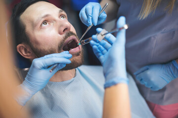 Young man at dentist. Shallow DOF. Developed from RAW; retouched with special care and attention;...