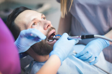 Young man at dentist. Shallow DOF. Developed from RAW; retouched with special care and attention;...