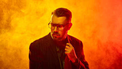 Man in pinstripe suit adjusts tie with firm expression amid thick orange fog symbolizing control...
