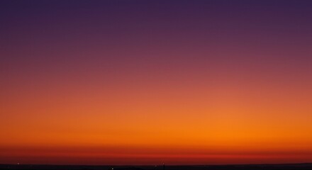 Fototapeta premium Vibrant Sunset Hues A Captivating Gradient of Orange, Red, and Purple Colors in the Evening Sky