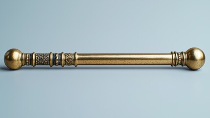 Ornate golden scepter on plain surface