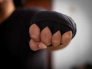 a boxer's hand in wrist black wraps