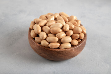 A bowl full of peeled peanuts closeup