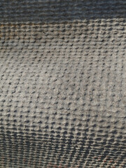 Textured grey surface. Rough texture and different shades create depth. Use for urban backgrounds, street scenes or architectural textures.