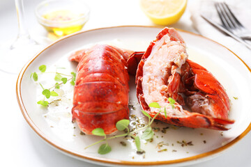 Delicious tails of boiled lobsters served on white table, closeup