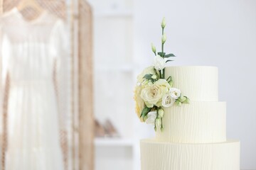 Delicious wedding cake with floral decor indoors, closeup. Space for text
