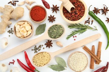 Different aromatic spices on white background, flat lay