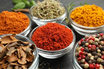 Different aromatic spices on grey table, closeup