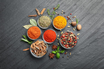 Different aromatic spices on grey table, flat lay