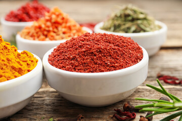 Different aromatic spices on wooden table, closeup