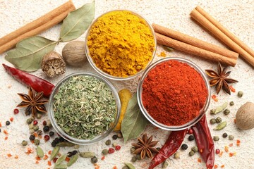 Different aromatic spices on color textured table, flat lay